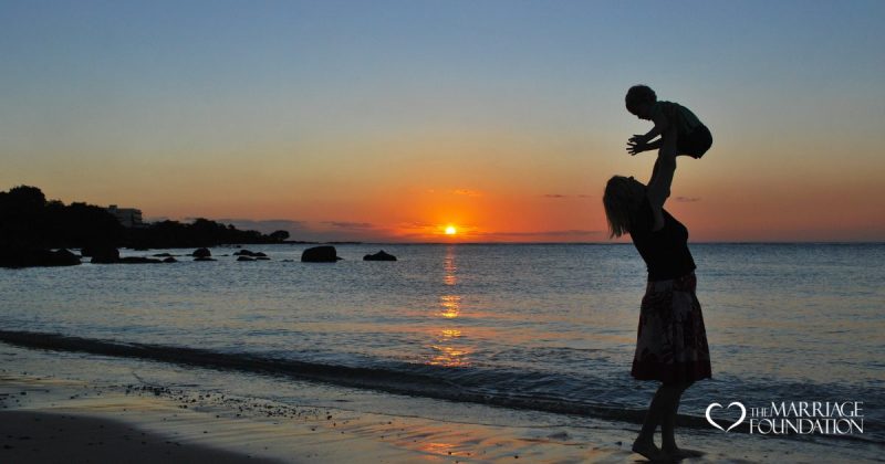 mother-playing-with-son-in-the-beach